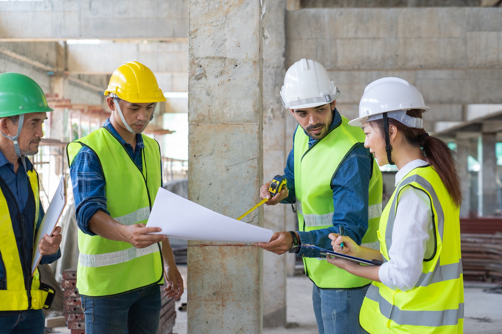 team of civil engineer inspect and discuss the building construction progress at site