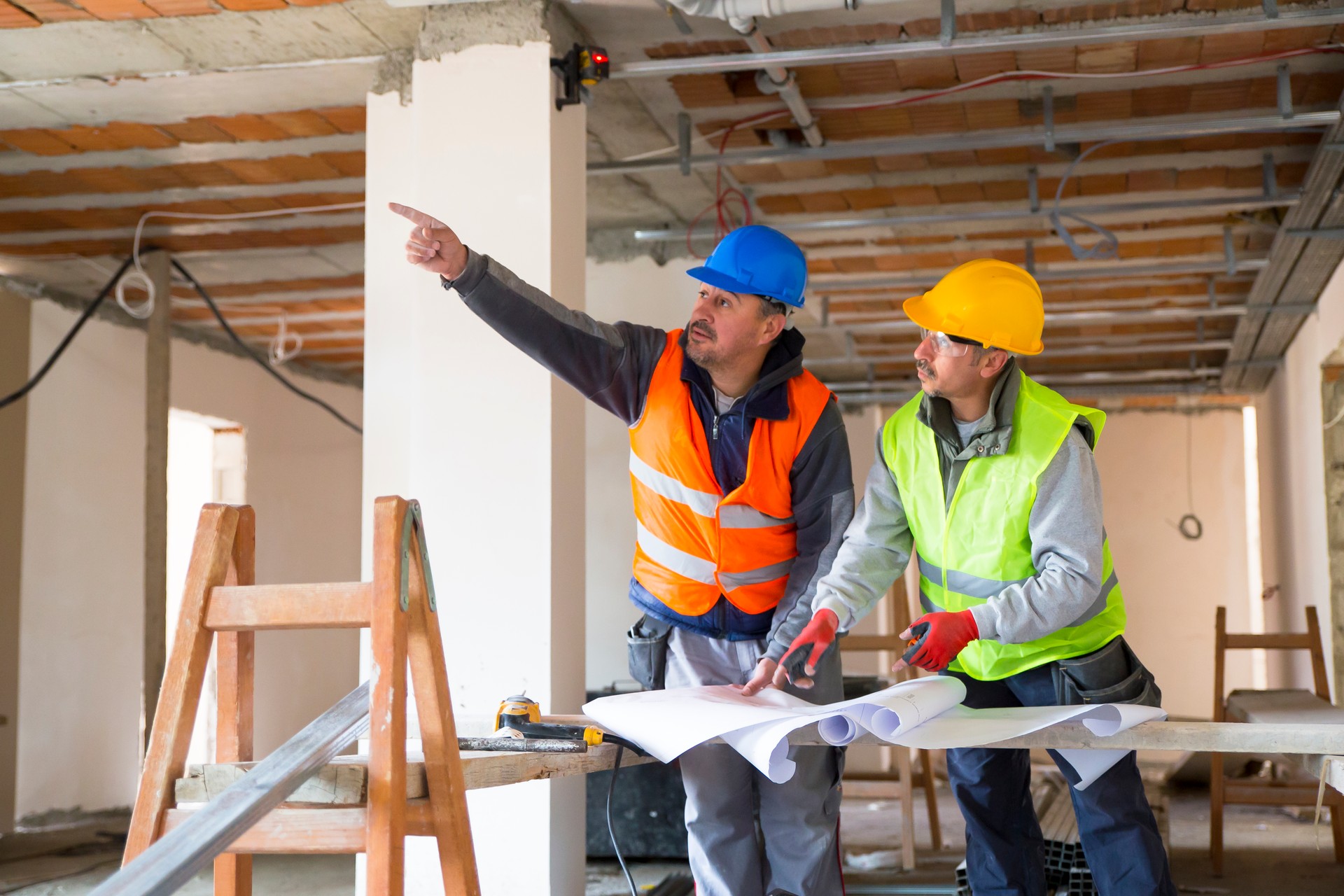 Construction worker looking at blueprints